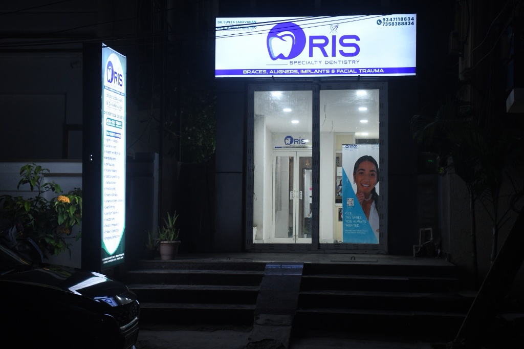 Real illuminated exterior building facade and signage of ORIS Speciality Dentistry on Road No. 1, Mathrusree Nagar, Miyapur